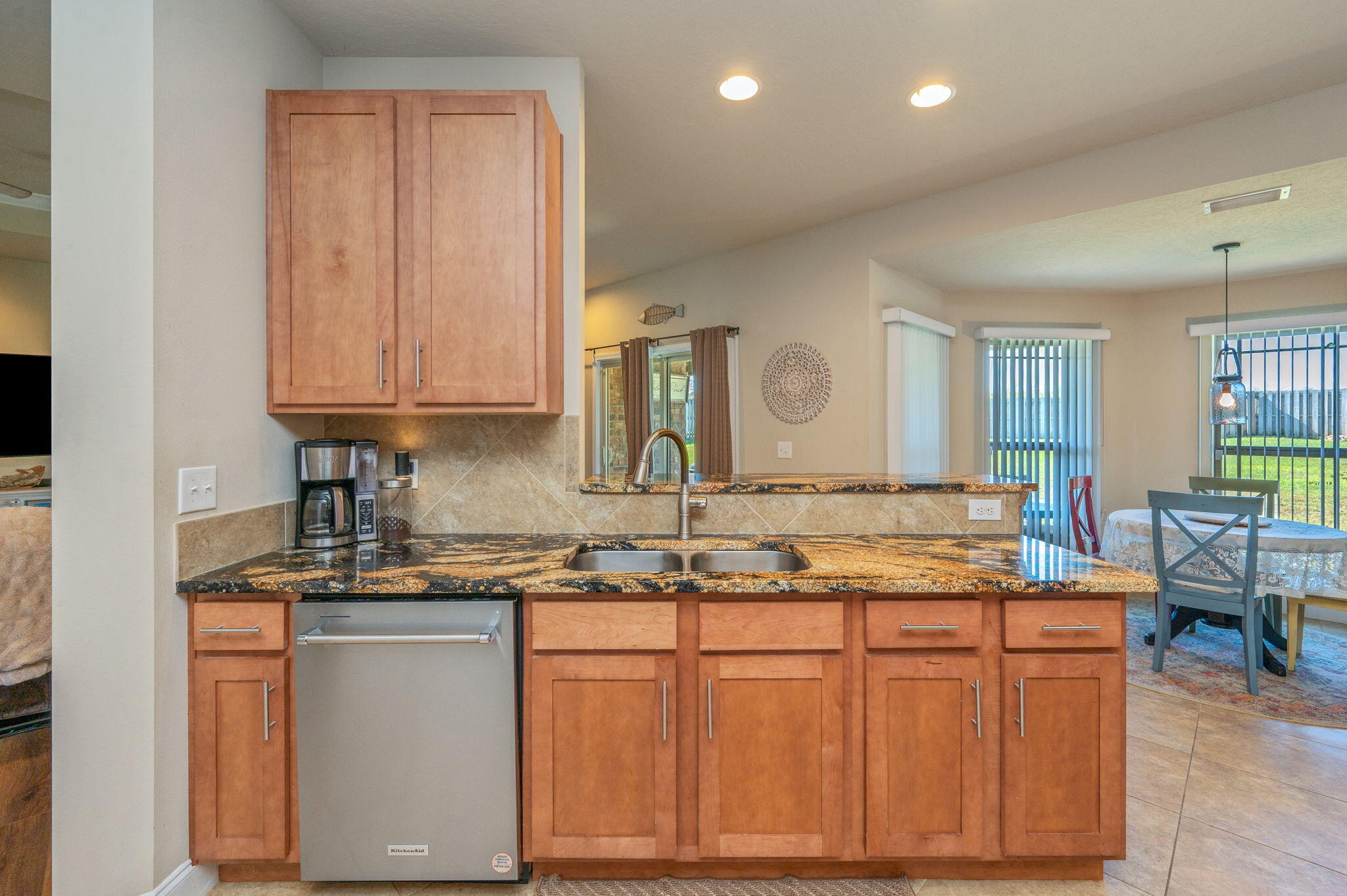 4675 Chanteuse Parkway Crestview, FL 32539 - Photo 16 of 48 a kitchen with kitchen island granite countertop wooden cabinets and a sink