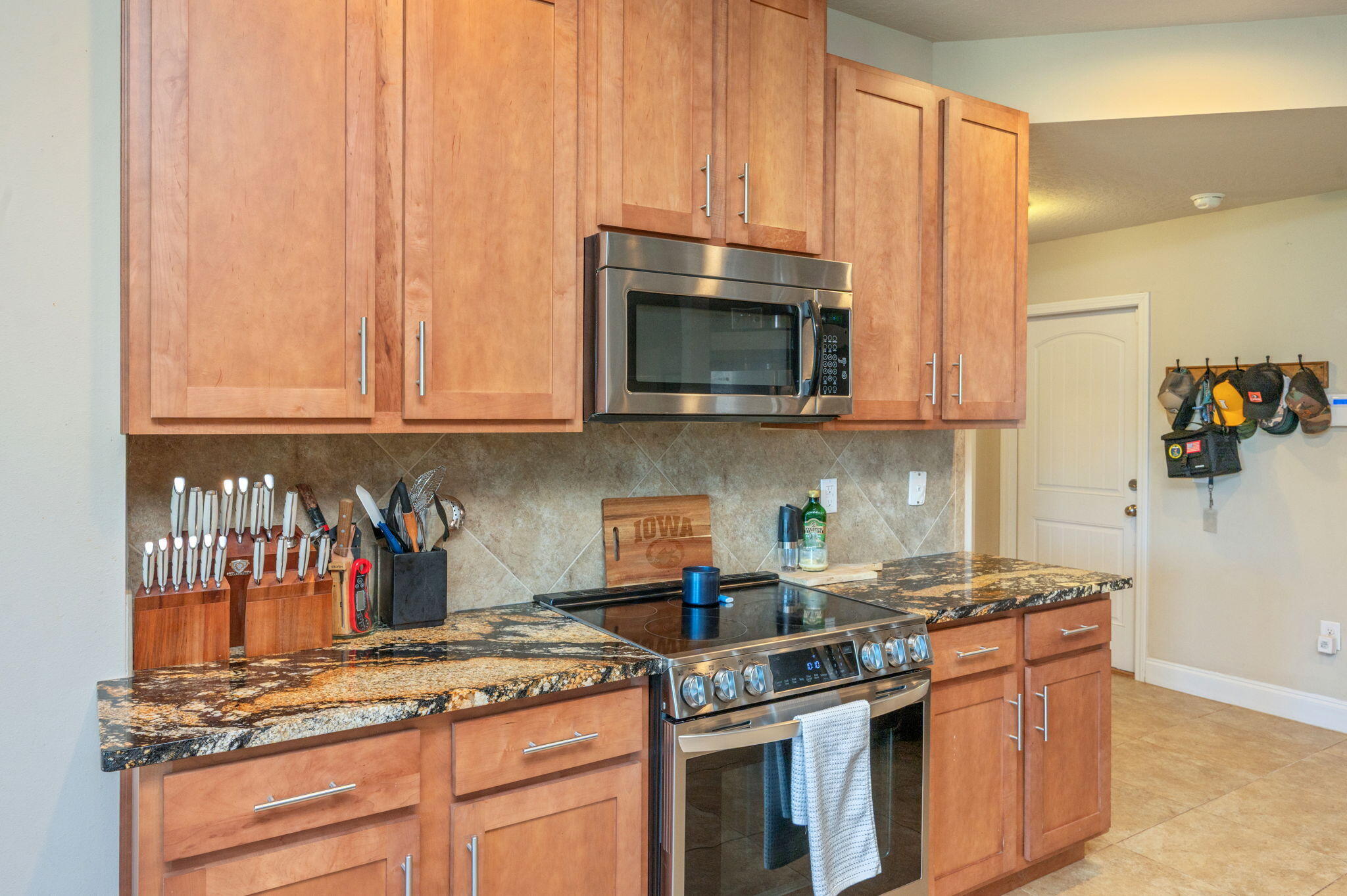 4675 Chanteuse Parkway Crestview, FL 32539 - Photo 17 of 48 a kitchen with stainless steel appliances granite countertop a stove a microwave and cabinets