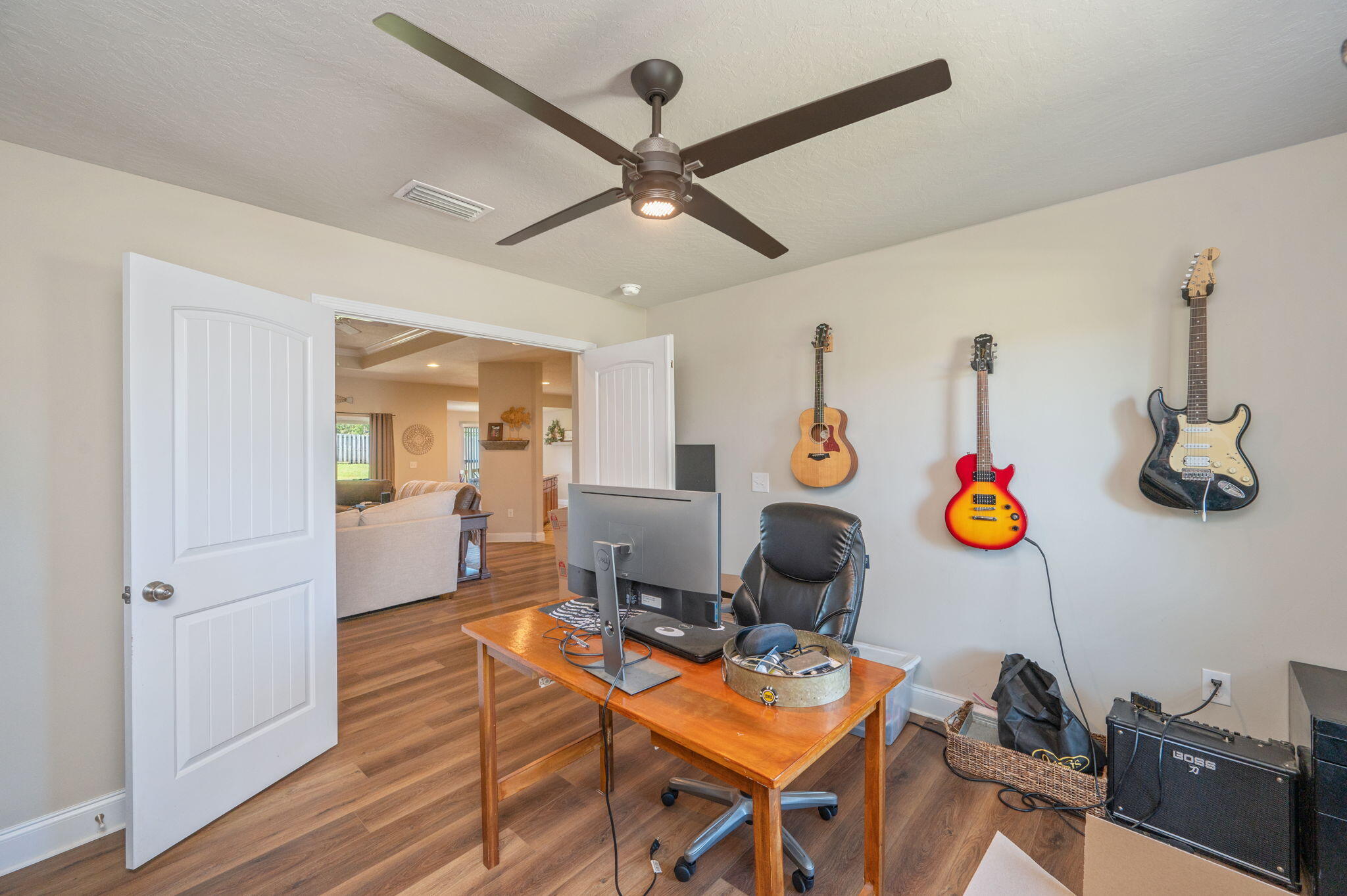 4675 Chanteuse Parkway Crestview, FL 32539 - Photo 21 of 48 a living room with dining room and wooden floor