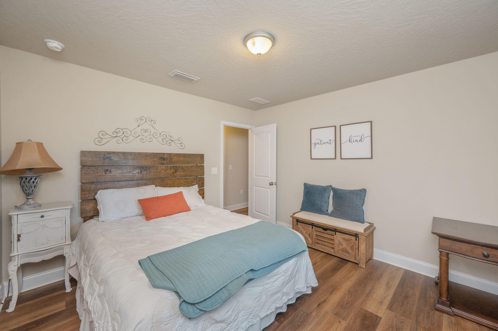 4675 Chanteuse Parkway Crestview, FL 32539 - Photo 33 of 48 a bedroom with a bed and wooden floor