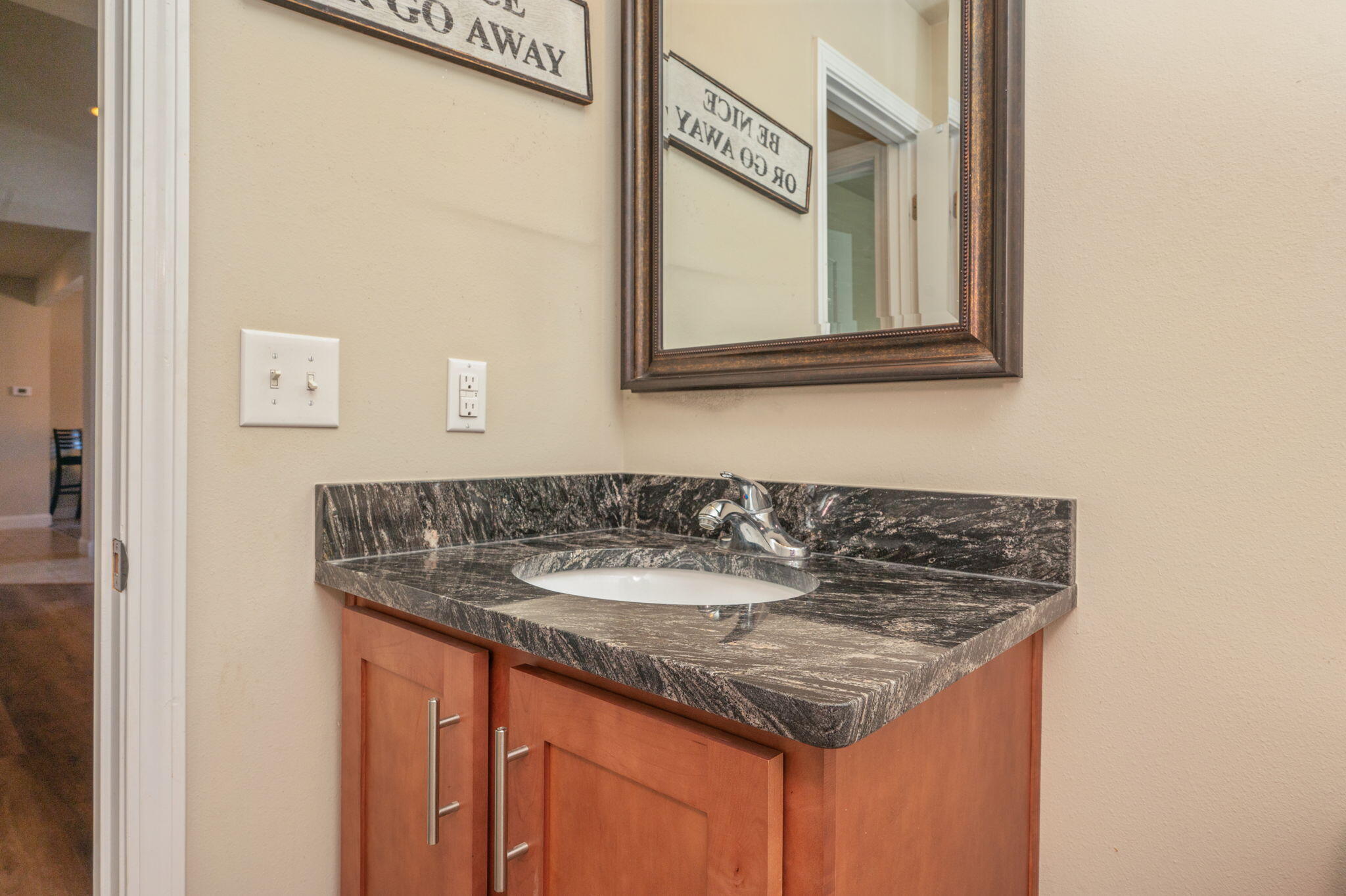 4675 Chanteuse Parkway Crestview, FL 32539 - Photo 37 of 48 a bathroom with a granite countertop sink and a mirror