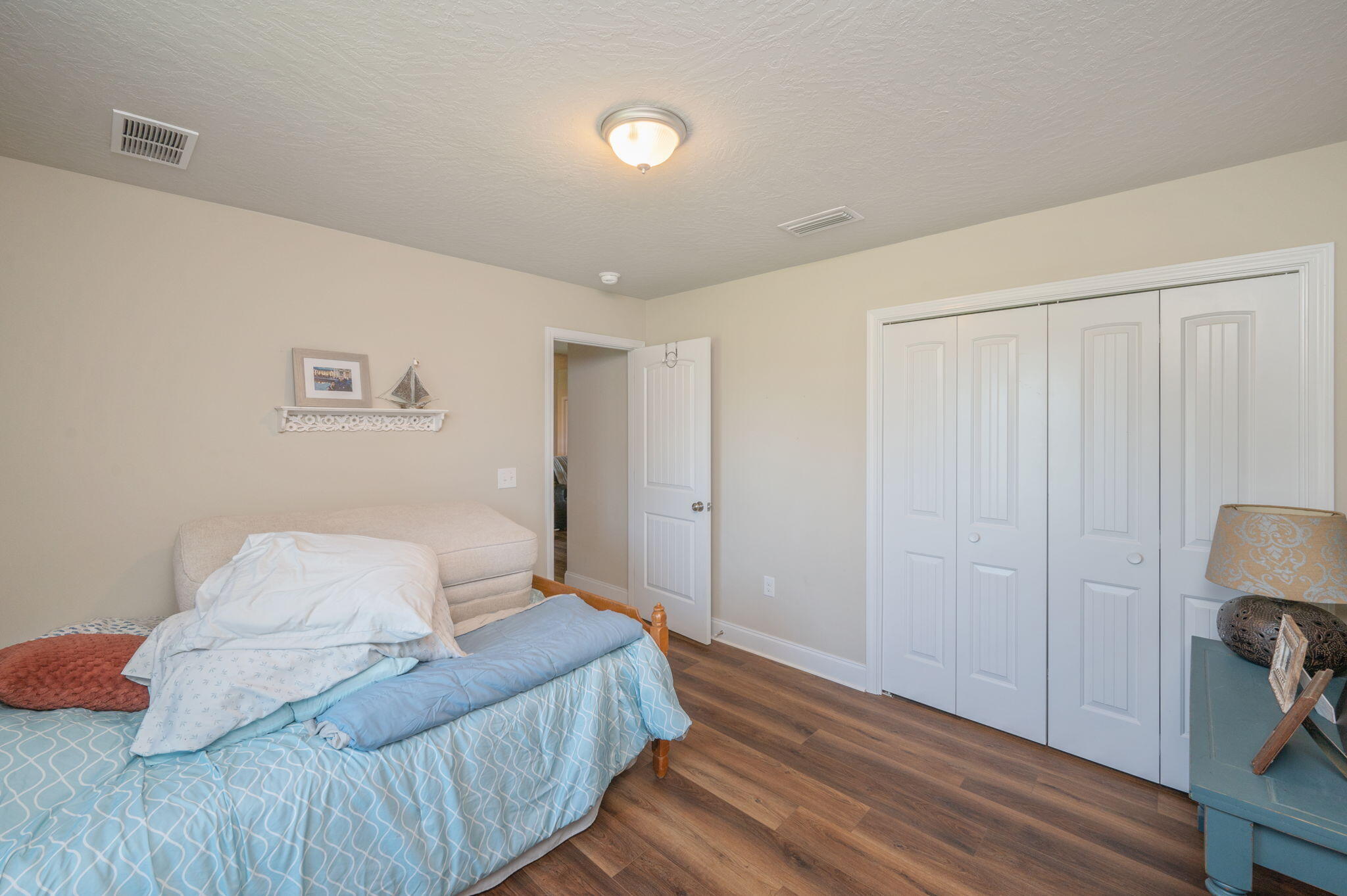 4675 Chanteuse Parkway Crestview, FL 32539 - Photo 40 of 48 a bedroom with a bed and a night stand