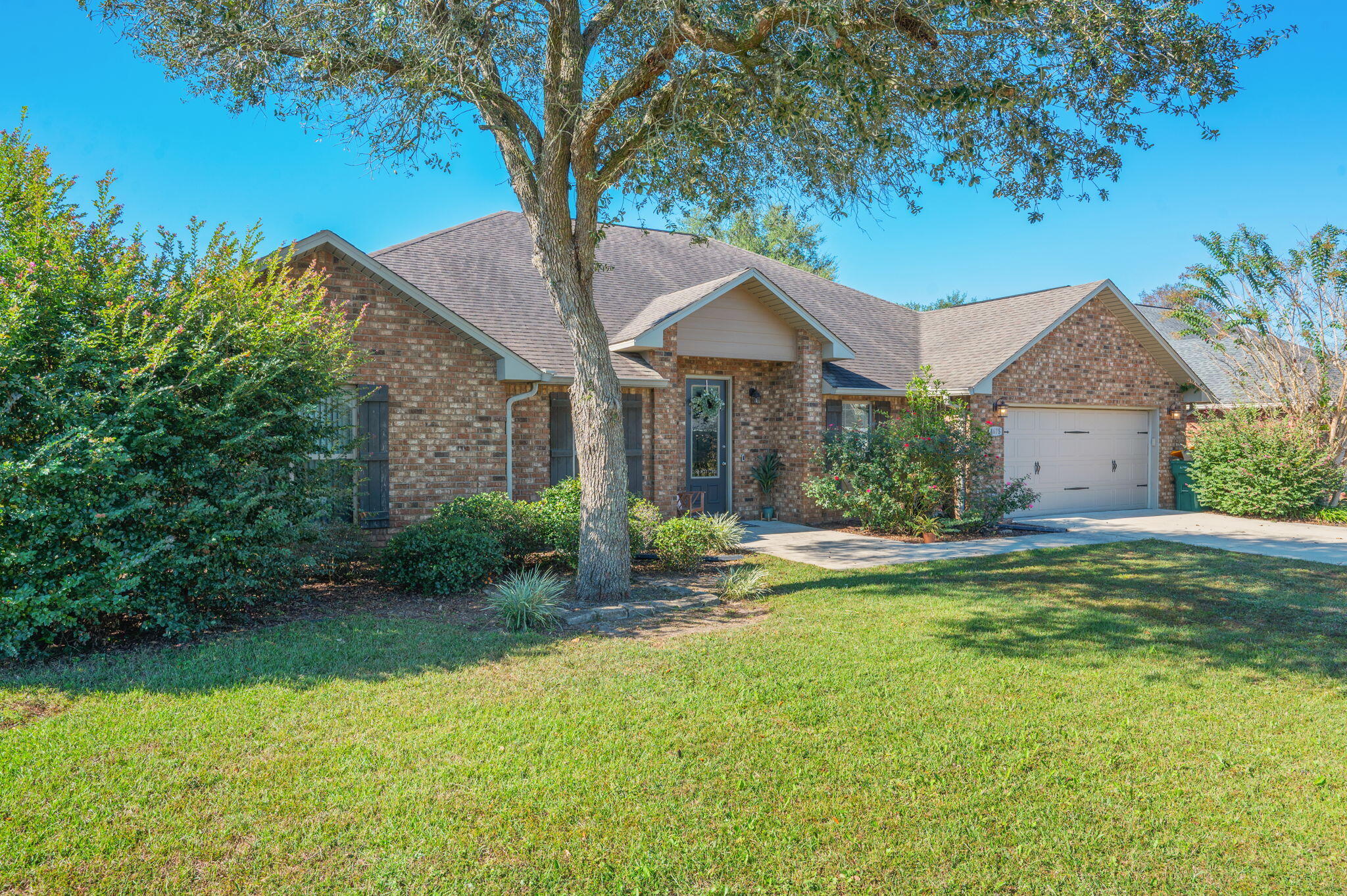 4675 Chanteuse Parkway Crestview, FL 32539 - Photo 4 of 48 a front view of a house with yard and green space