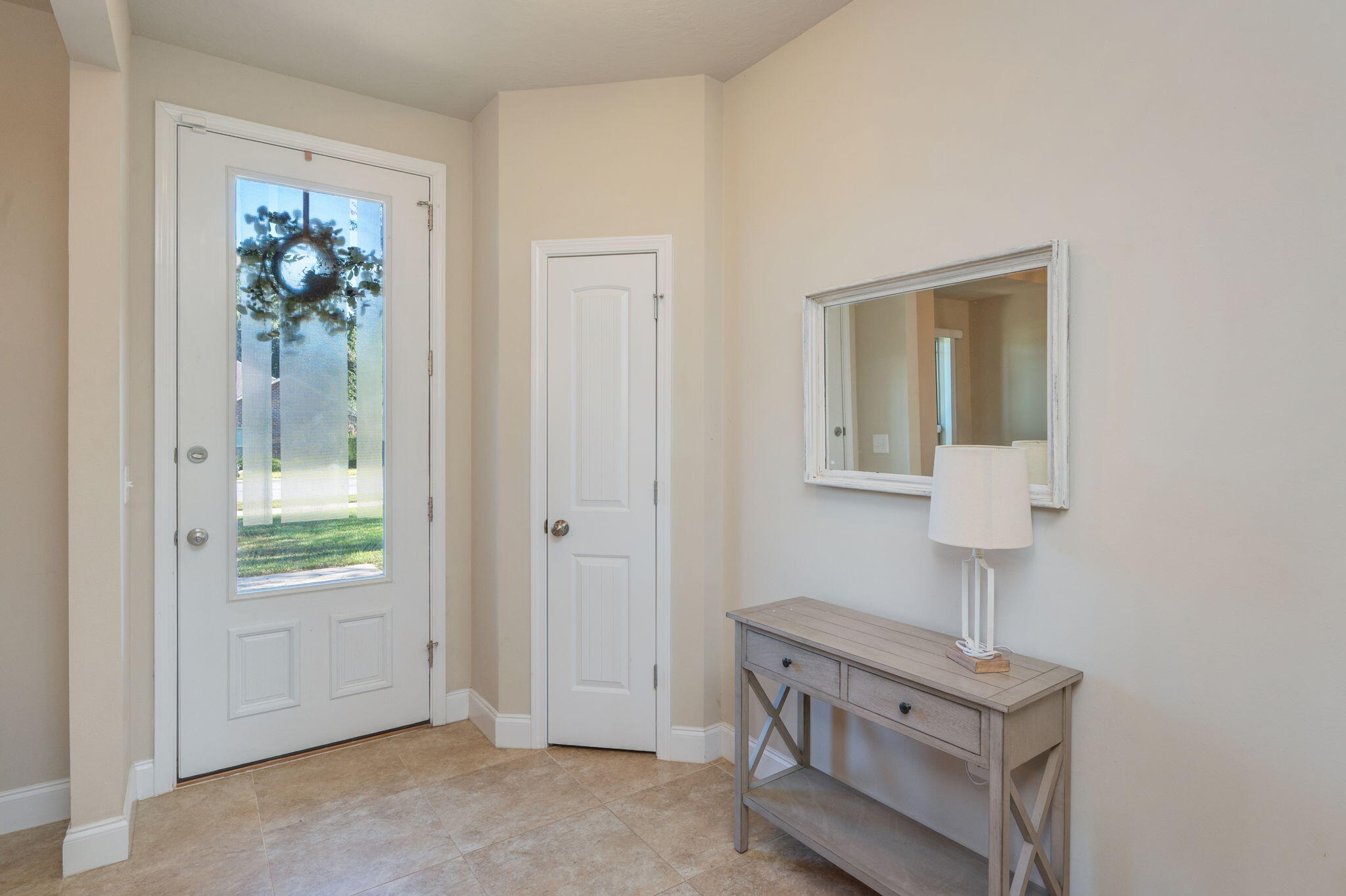 4675 Chanteuse Parkway Crestview, FL 32539 - Photo 6 of 48 a room with a bed and a lamp on dresser