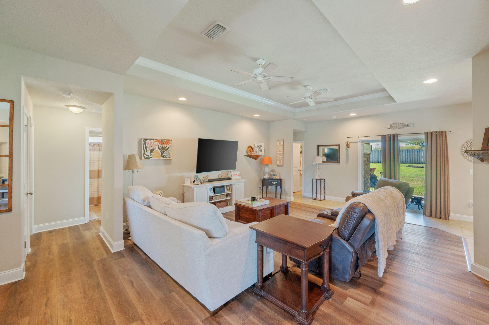 4675 Chanteuse Parkway Crestview, FL 32539 - Photo 7 of 48 a living room with furniture a wooden floor and a flat screen tv