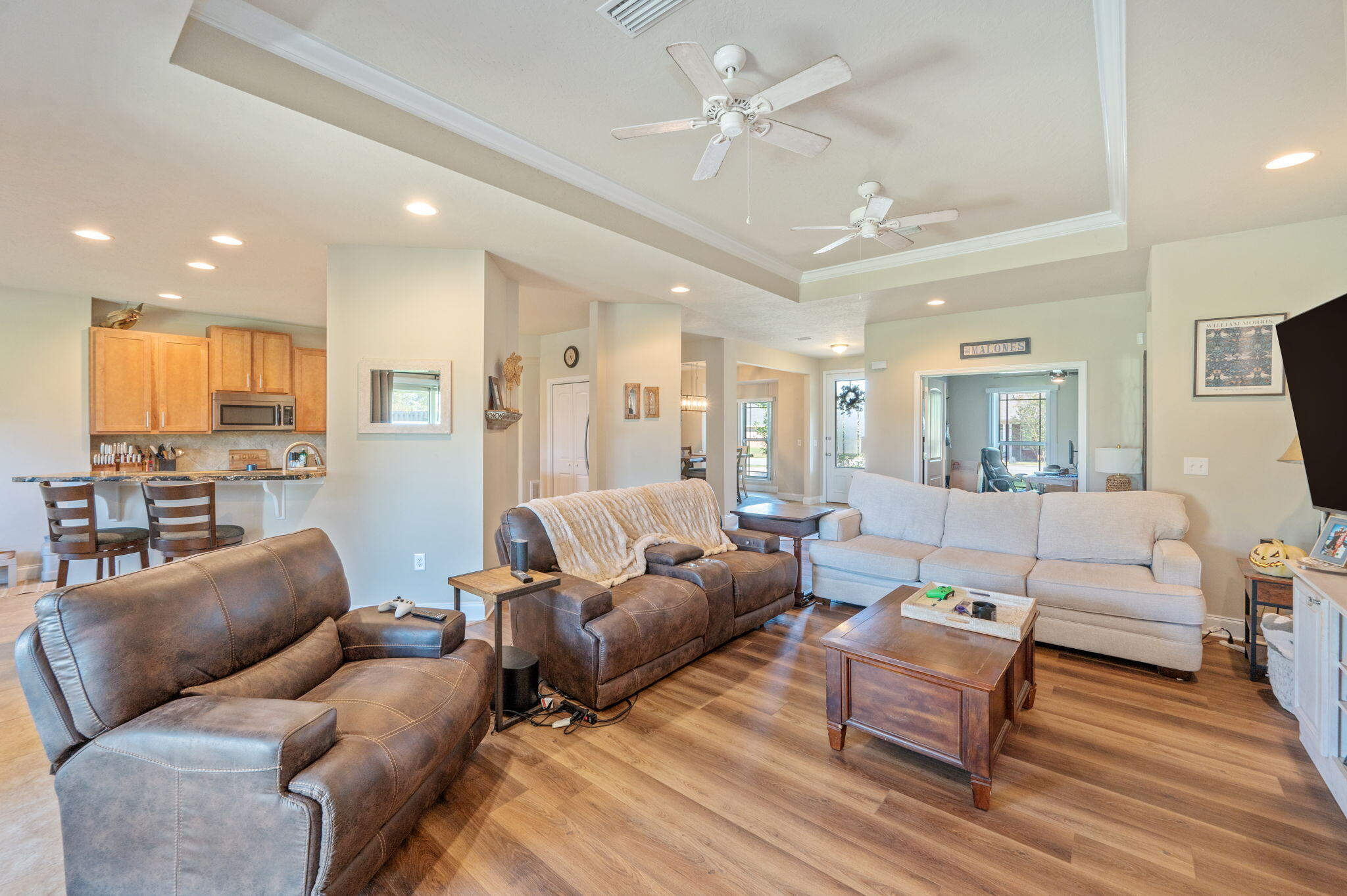 4675 Chanteuse Parkway Crestview, FL 32539 - Photo 8 of 48 a living room with furniture wooden floor and a view of kitchen