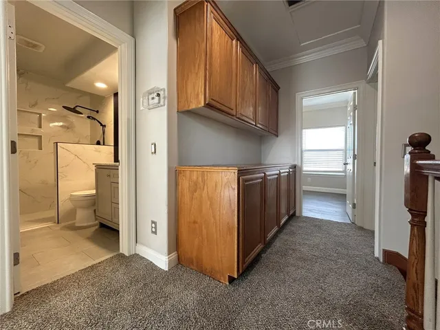 a view of an empty room with a ceiling fan