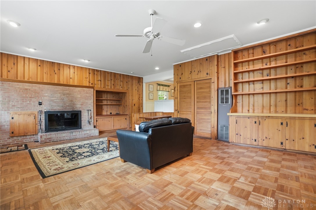 6119 Flemington Road Dayton, OH 45459 - Photo 23 of 76 This inviting living area features a charming fireplace and warm wood paneling throughout.