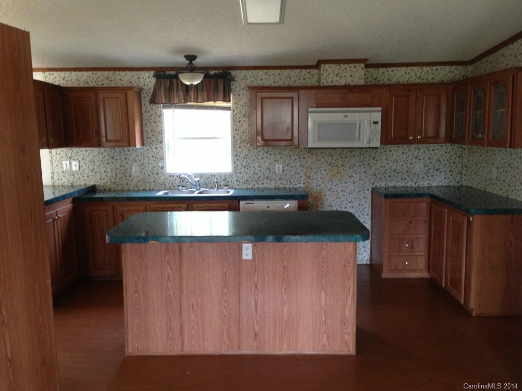 1099 South Castleview Road, Unit 67 Salisbury, NC 28146 - Photo 3 of 15 a kitchen with stainless steel appliances granite countertop wooden cabinets a stove top oven a sink and dishwasher