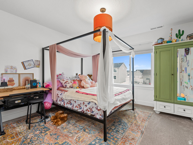 627 South Meade Street Mapleton, UT 84664 - Photo 6 of 48 Bright bedroom featuring a large window, a central drum pendant light fixture, and neutral carpeting