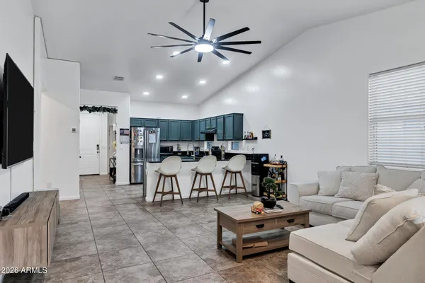 a living room with furniture and kitchen view