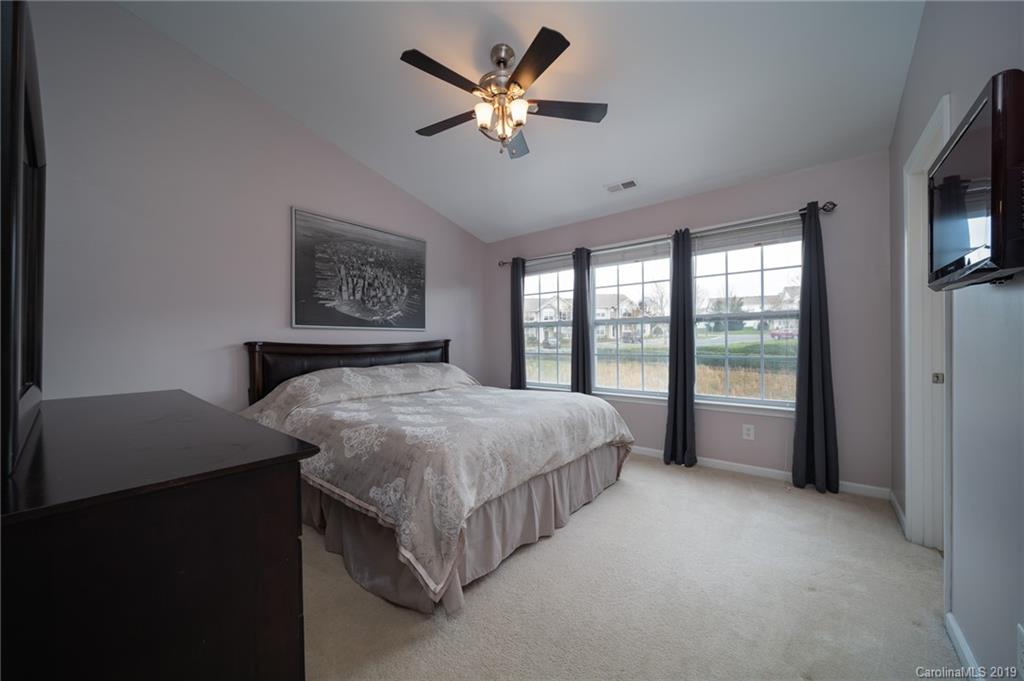 980 Copperstone Lane Fort Mill, SC 29708 - Photo 17 of 27 a bedroom with a large bed and a large window