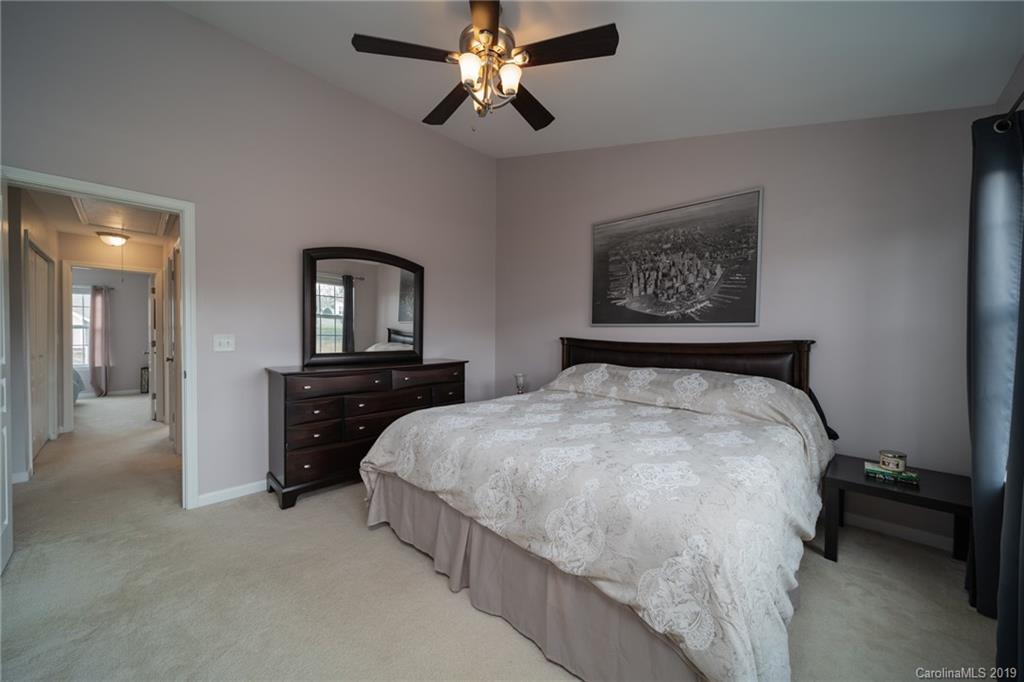 980 Copperstone Lane Fort Mill, SC 29708 - Photo 18 of 27 a spacious bedroom with a bed and a chandelier