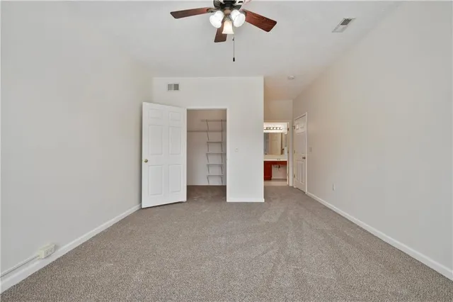a view of an empty room with a ceiling fan