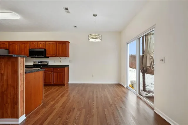 a kitchen with sink window and stainless steel appliances