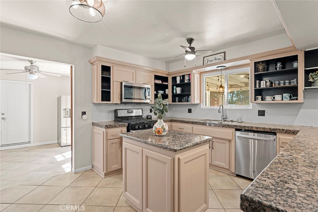 40069 East Newport Road Hemet, CA 92543 - Photo 11 of 64 a kitchen with a sink stove top oven and refrigerator