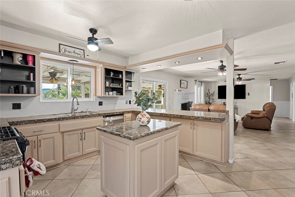 40069 East Newport Road Hemet, CA 92543 - Photo 13 of 64 a kitchen with a sink stove and cabinets