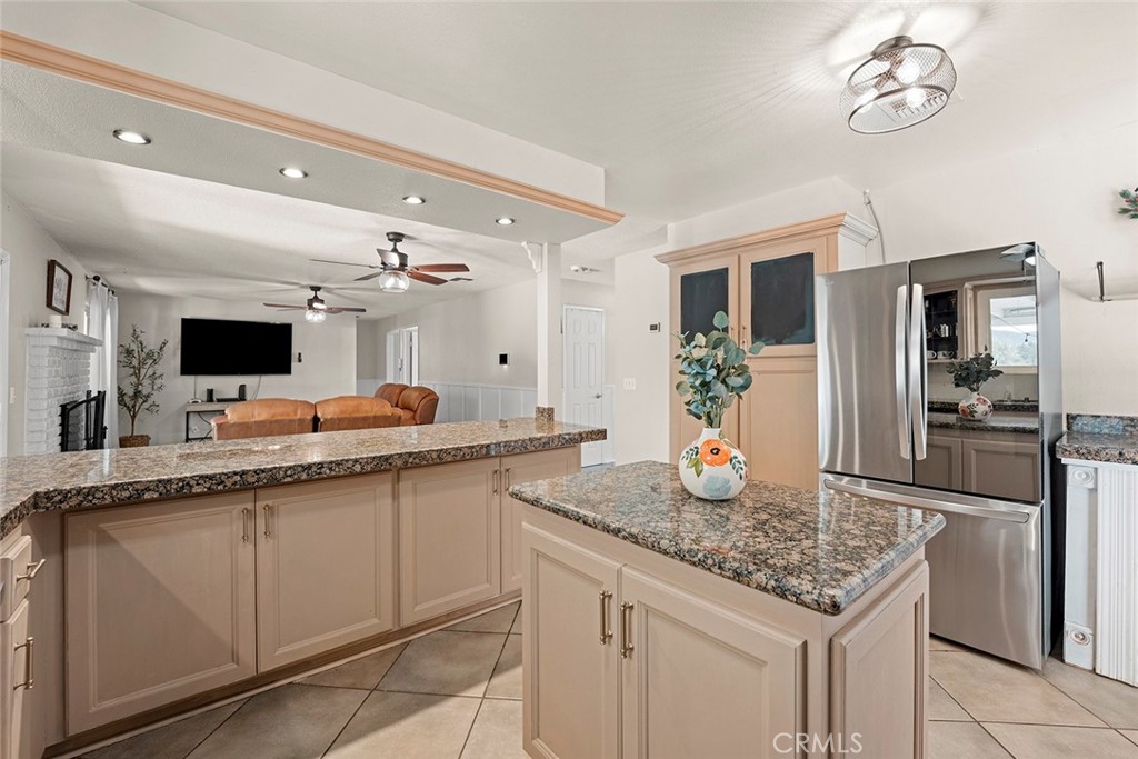 40069 East Newport Road Hemet, CA 92543 - Photo 14 of 64 a kitchen with kitchen island granite countertop a sink and cabinets
