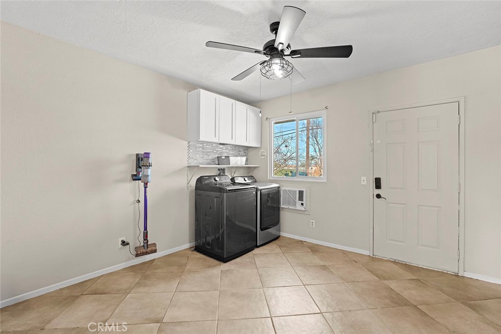 40069 East Newport Road Hemet, CA 92543 - Photo 17 of 64 a view of a kitchen with a stove cabinets and a ceiling fan