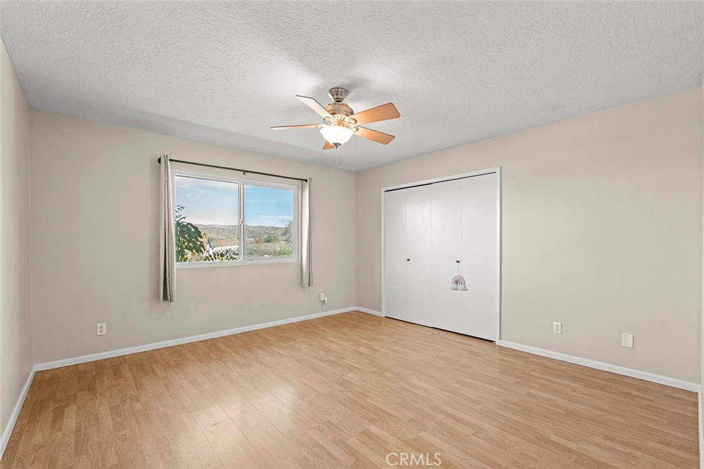 40069 East Newport Road Hemet, CA 92543 - Photo 19 of 64 a view of empty room with wooden floor and fan