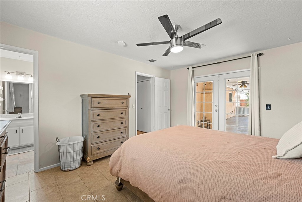 40069 East Newport Road Hemet, CA 92543 - Photo 27 of 64 a bedroom with a bed and a ceiling fan