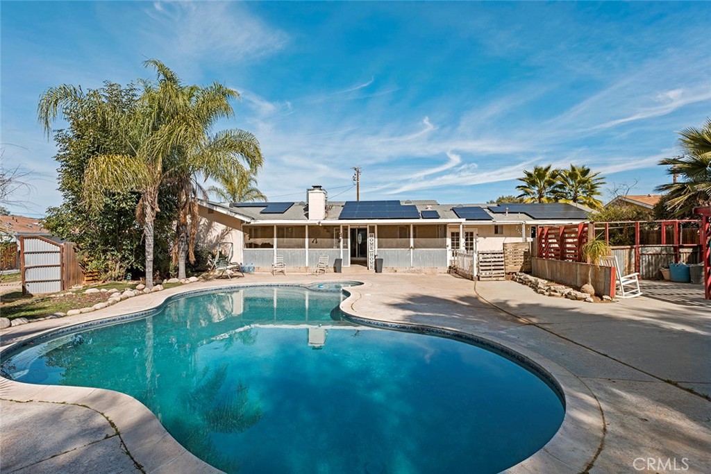 40069 East Newport Road Hemet, CA 92543 - Photo 36 of 64 a view of a swimming pool with a yard