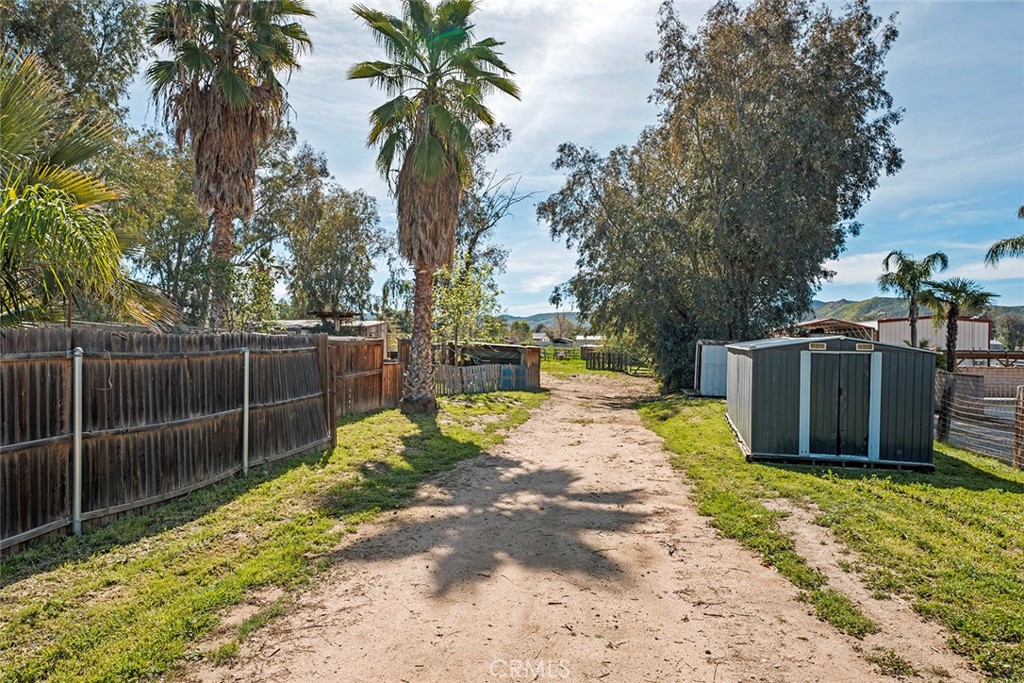 40069 East Newport Road Hemet, CA 92543 - Photo 39 of 64 a view of a backyard with potted plants and large trees