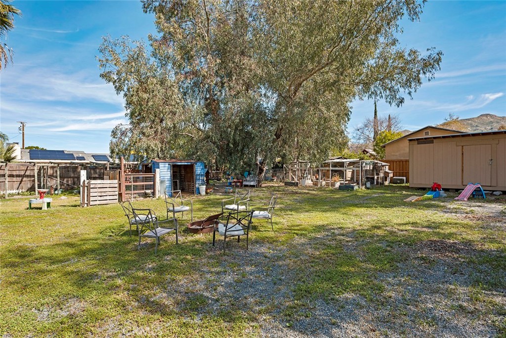 40069 East Newport Road Hemet, CA 92543 - Photo 43 of 64 a view of a house with swimming pool next to a yard
