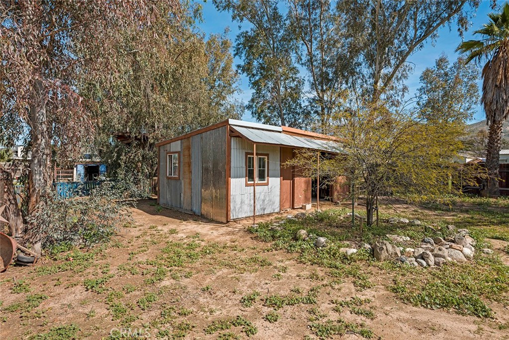 40069 East Newport Road Hemet, CA 92543 - Photo 44 of 64 a white house that has a tree in front of it
