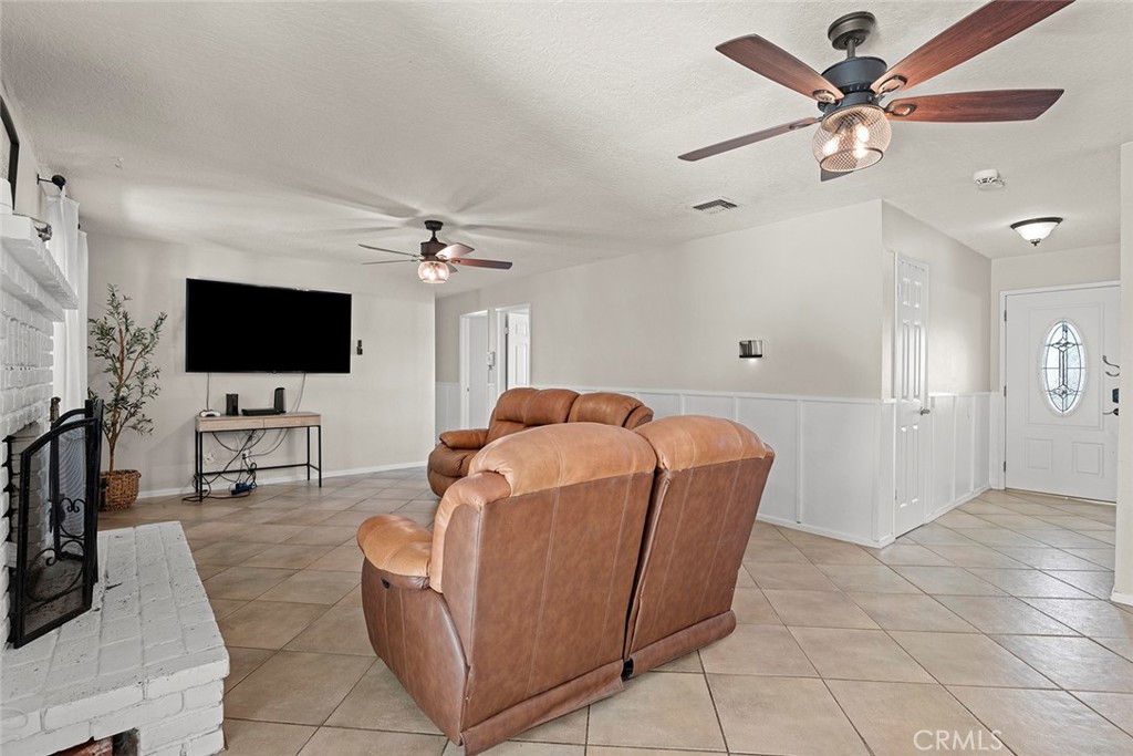 40069 East Newport Road Hemet, CA 92543 - Photo 9 of 64 a living room with furniture and a flat screen tv