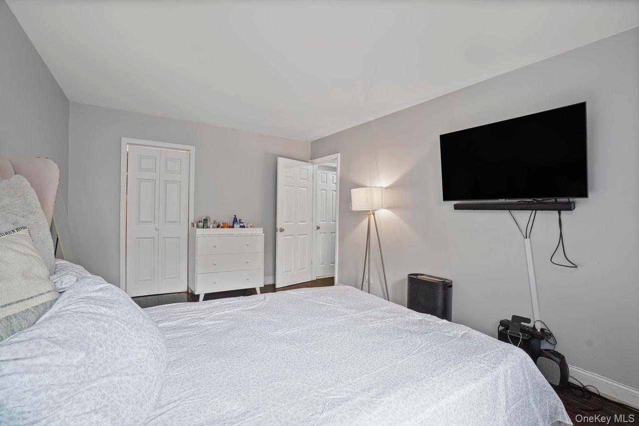 1190 East 53rd Street, Unit 2A Brooklyn, NY 11234 - Photo 7 of 11 a bedroom with a bed and a flat screen tv