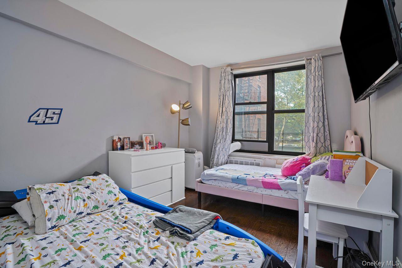1190 East 53rd Street, Unit 2A Brooklyn, NY 11234 - Photo 8 of 11 a bed room with a bed and a chair