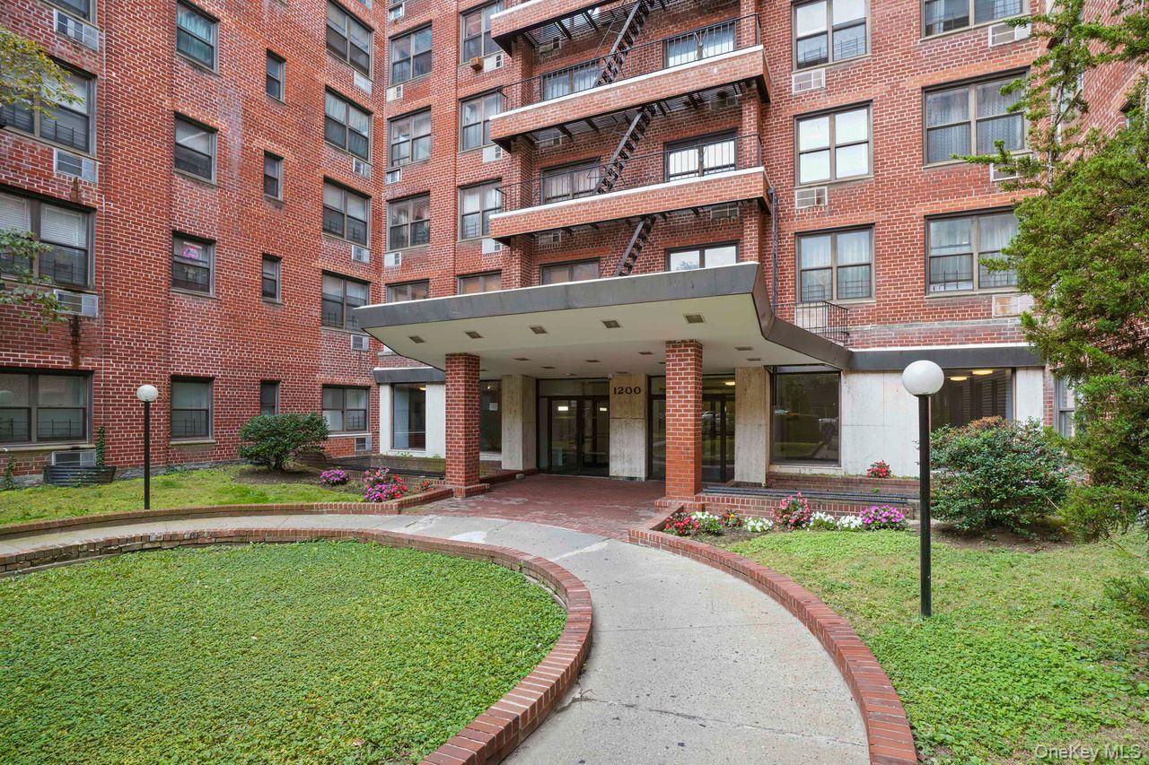 1190 East 53rd Street, Unit 2A Brooklyn, NY 11234 - Photo 10 of 11 front view of a building with a garden