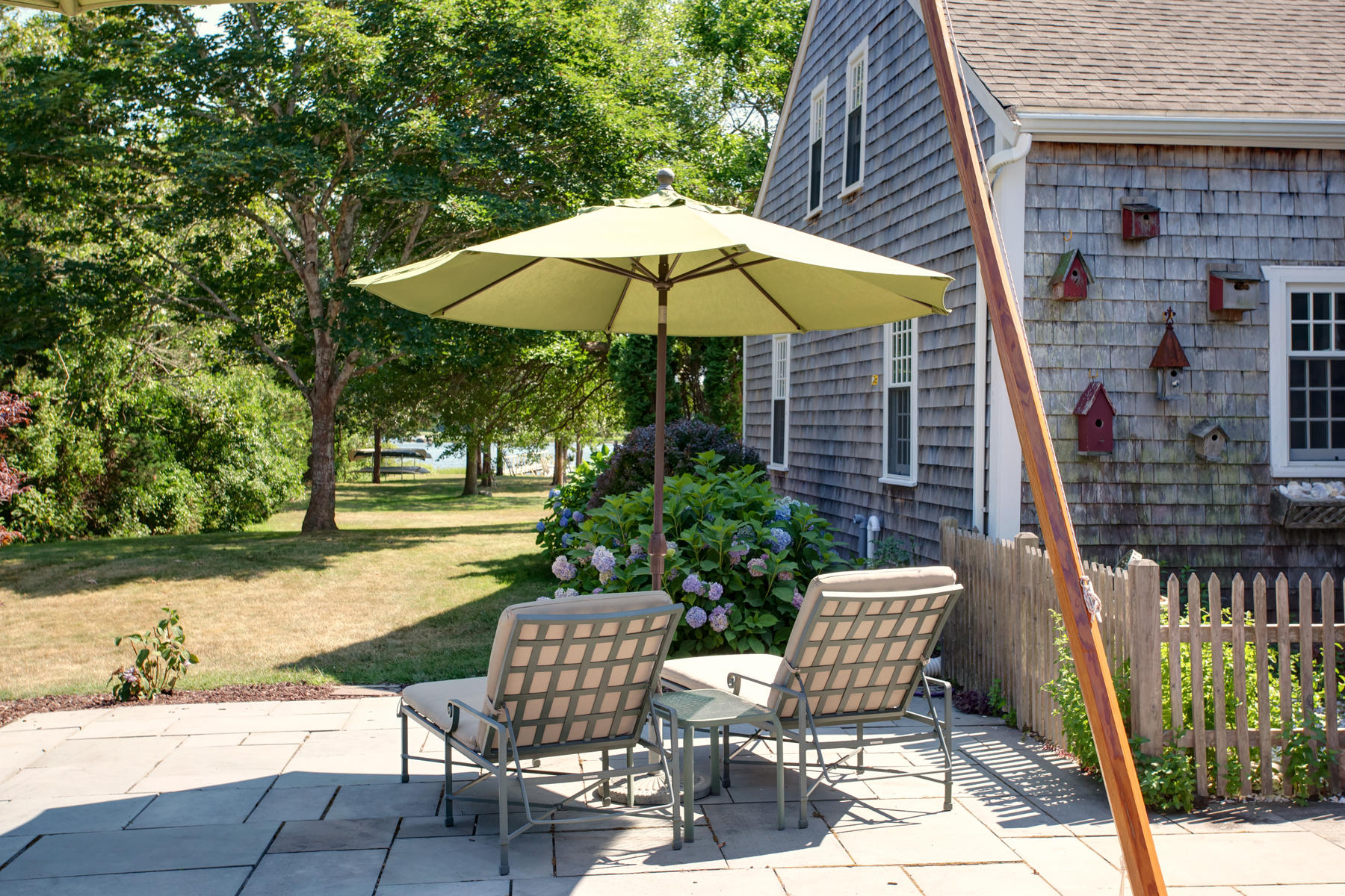 2 Plow Penny Road Bourne, MA 02532 - Photo 13 of 32 an outdoor space with furniture and umbrella