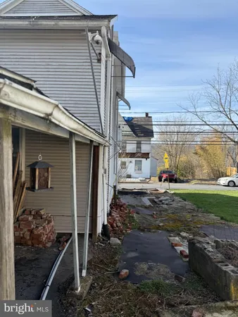 a view of a dry yard with wooden fence