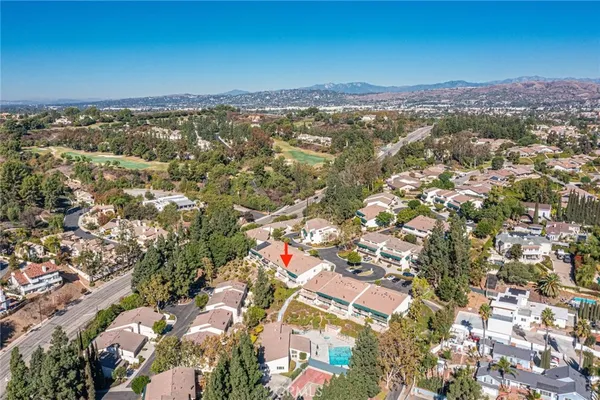 an aerial view of residential building with yard