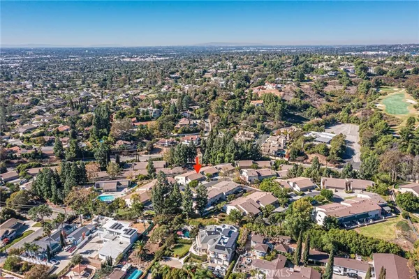 an aerial view of residential building with yard