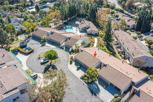 an aerial view of a residential houses with outdoor space
