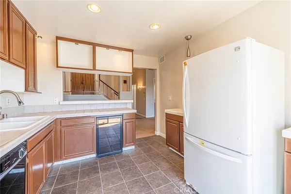 a kitchen with kitchen island a large window cabinets and stainless steel appliances