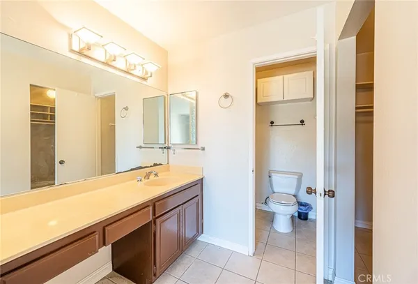 a bathroom with a granite countertop shower and a toilet