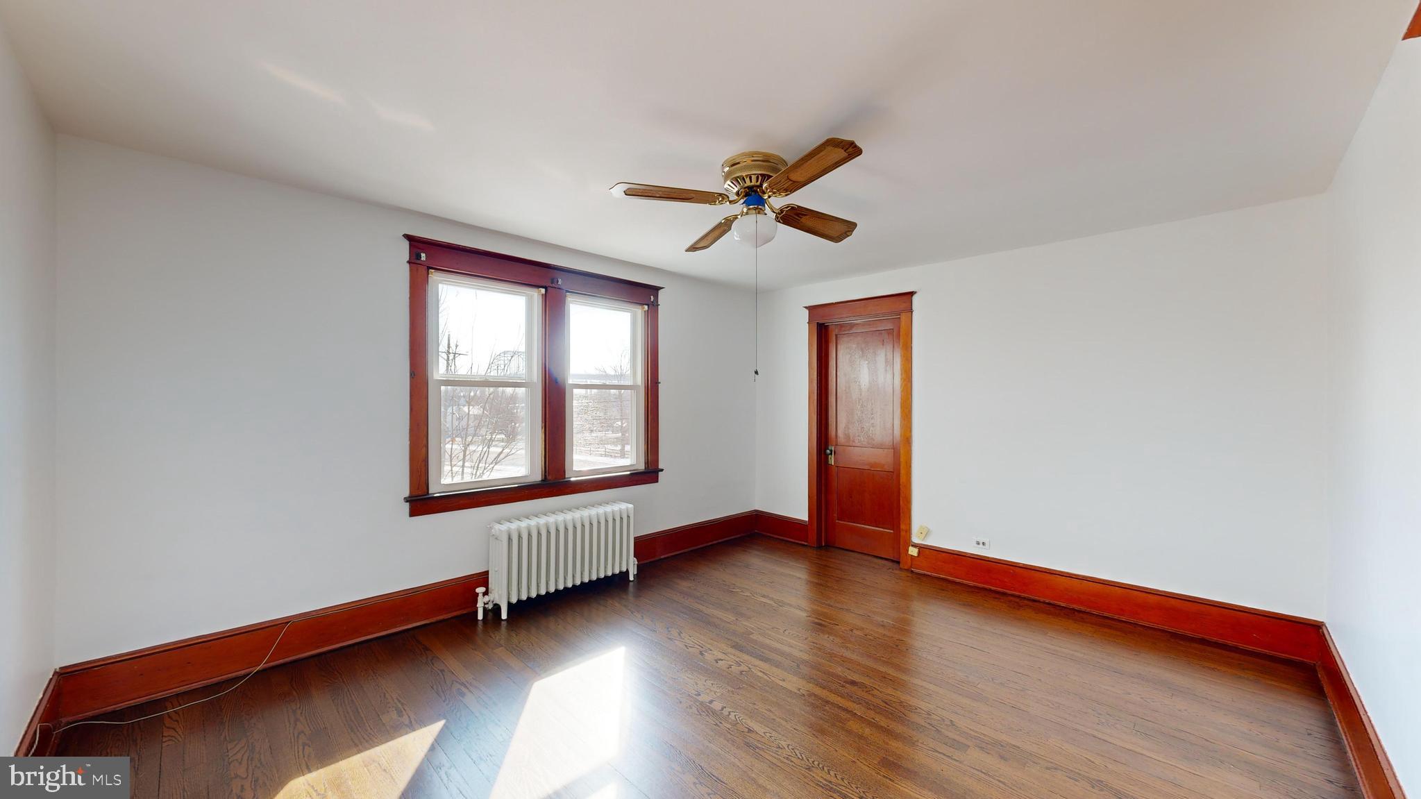 213 Broad Street St. Georges, DE 19733 - Photo 21 of 66 a view of an empty room with window and wooden floor