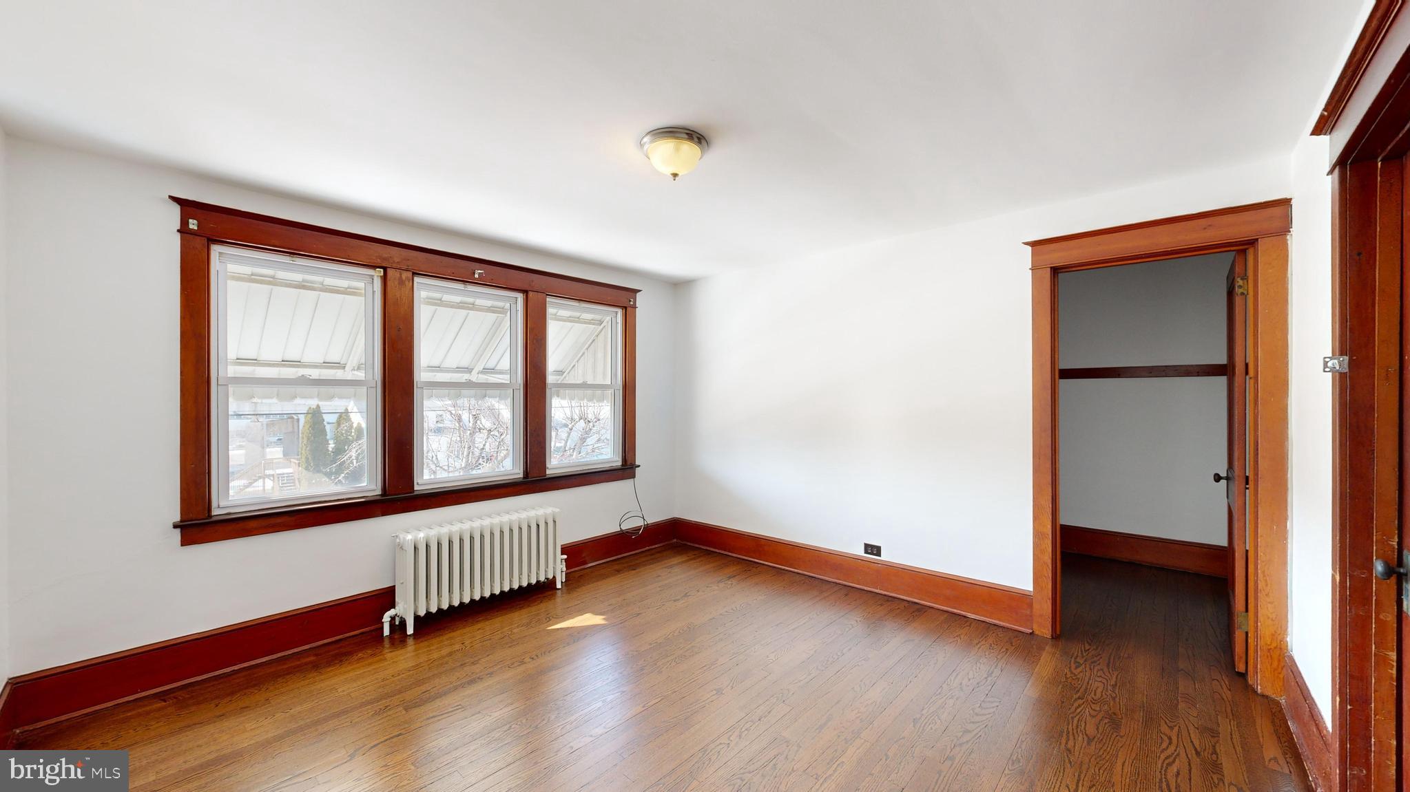 213 Broad Street St. Georges, DE 19733 - Photo 22 of 66 an empty room with wooden floor and windows