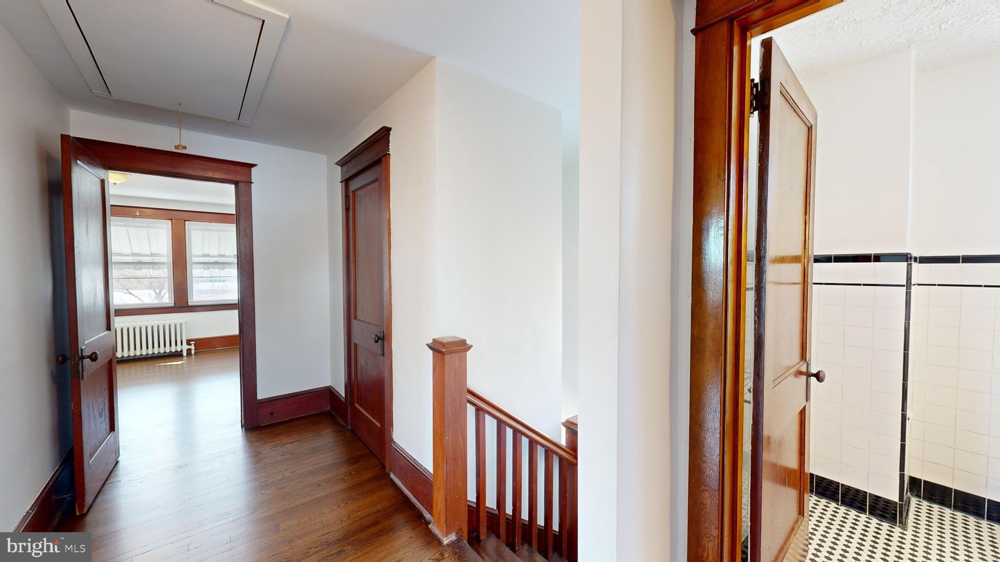 213 Broad Street St. Georges, DE 19733 - Photo 26 of 66 a view of a hallway with wooden floor and furniture
