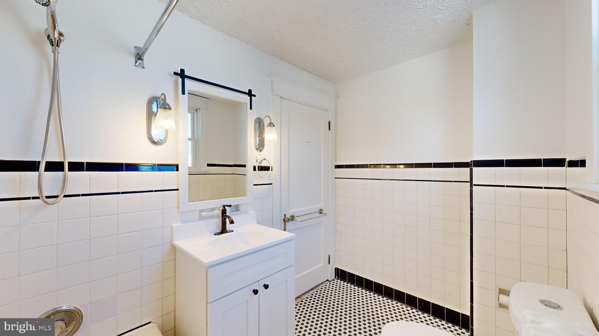 213 Broad Street St. Georges, DE 19733 - Photo 27 of 66 a bathroom with a sink a mirror and shower