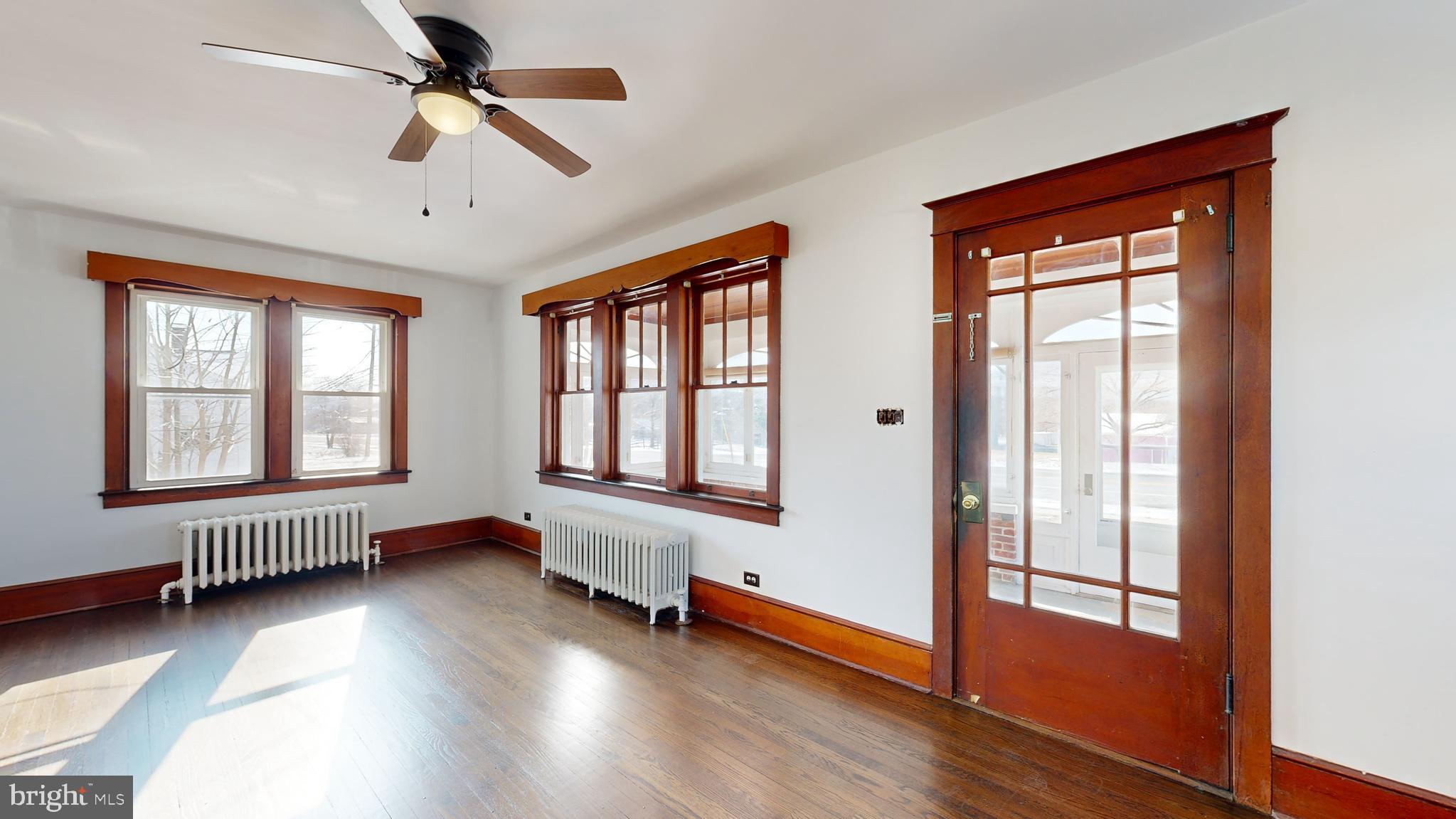 213 Broad Street St. Georges, DE 19733 - Photo 61 of 66 a view of an empty room with wooden floor and a window