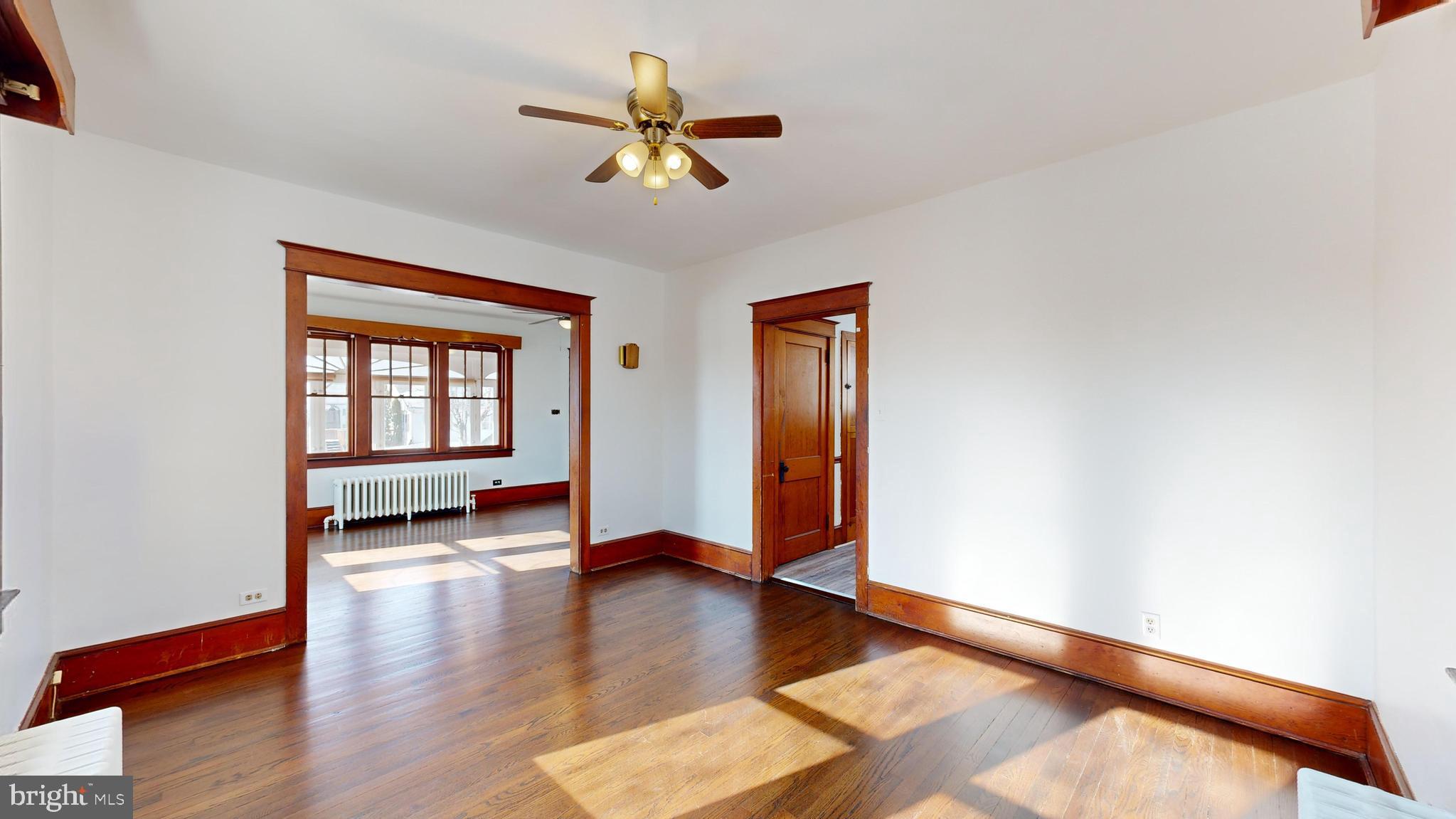 213 Broad Street St. Georges, DE 19733 - Photo 8 of 66 a view of livingroom with hardwood floor and kitchen view