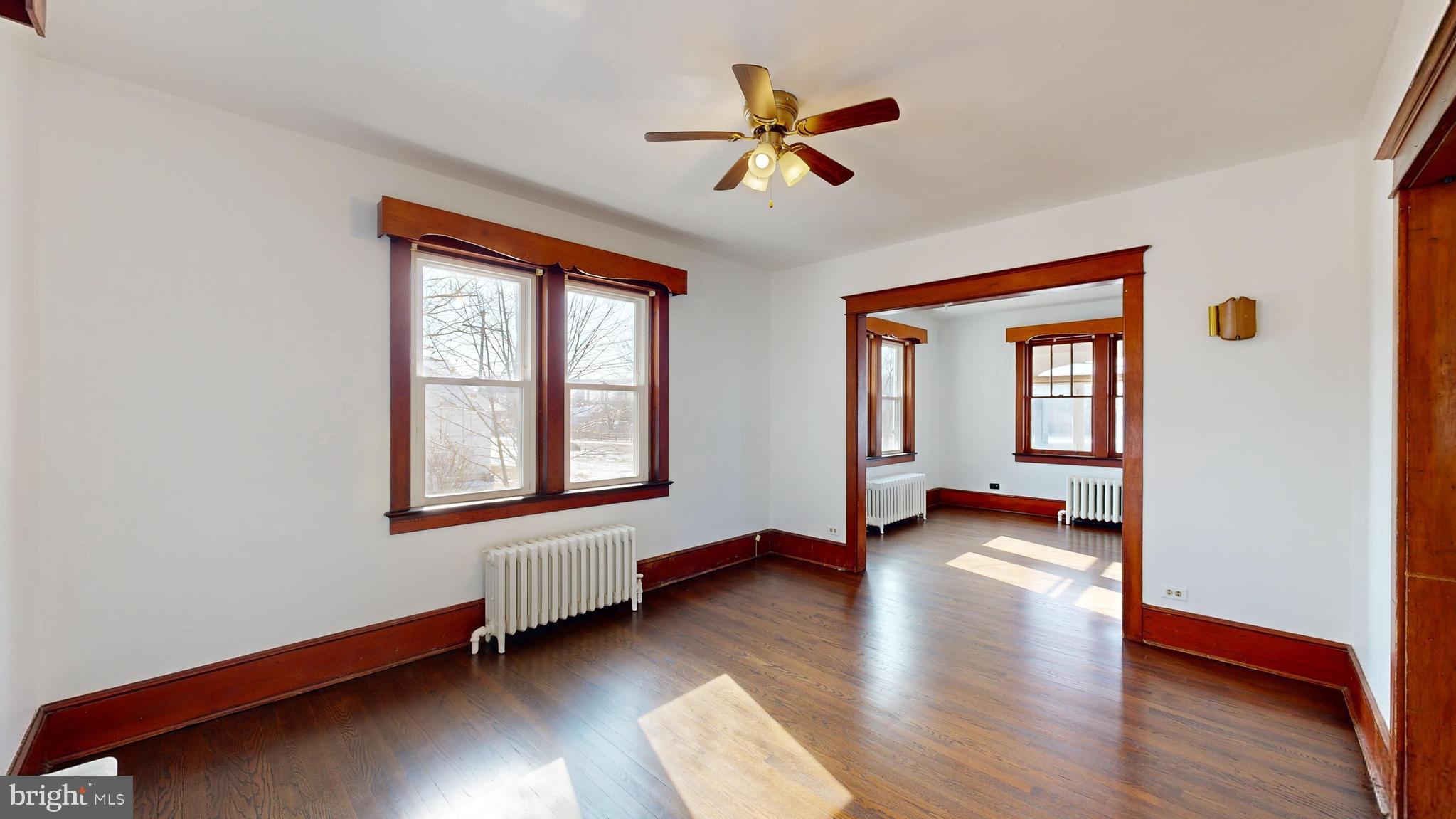 213 Broad Street St. Georges, DE 19733 - Photo 9 of 66 a view of livingroom with hardwood floor and a ceiling fan