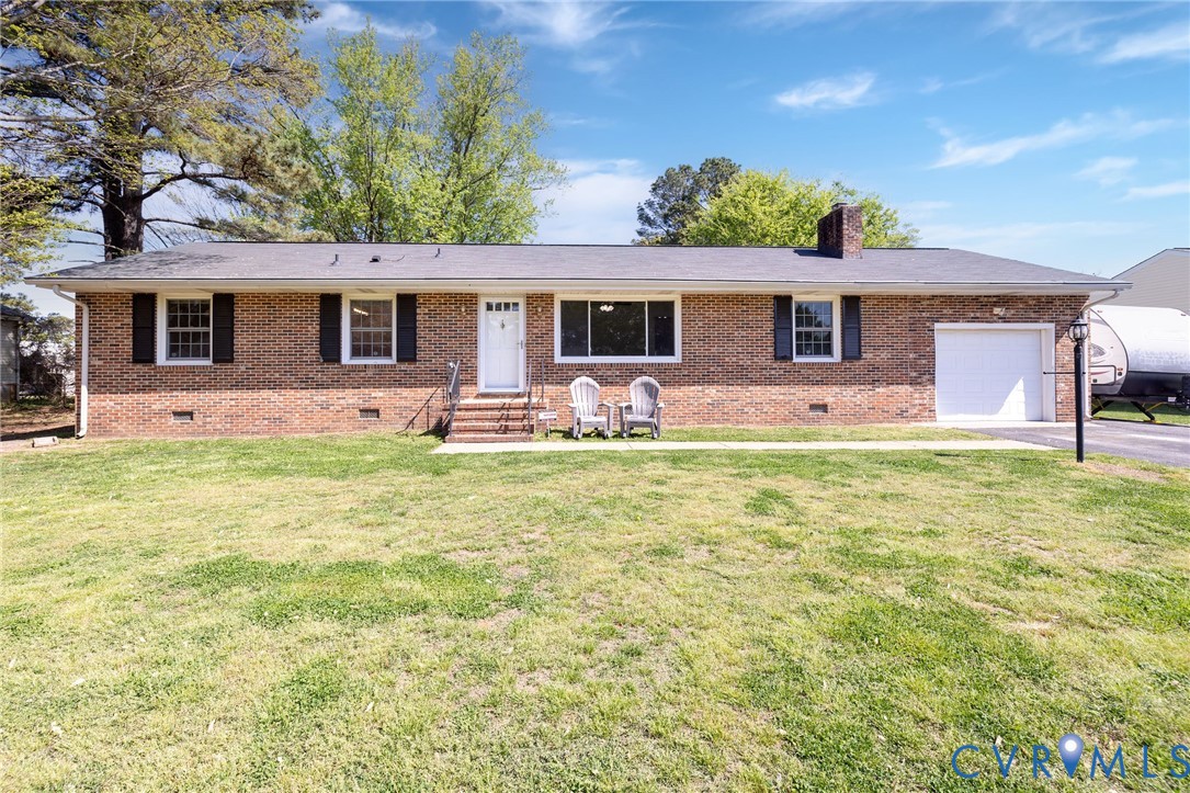 a front view of house with yard having patio