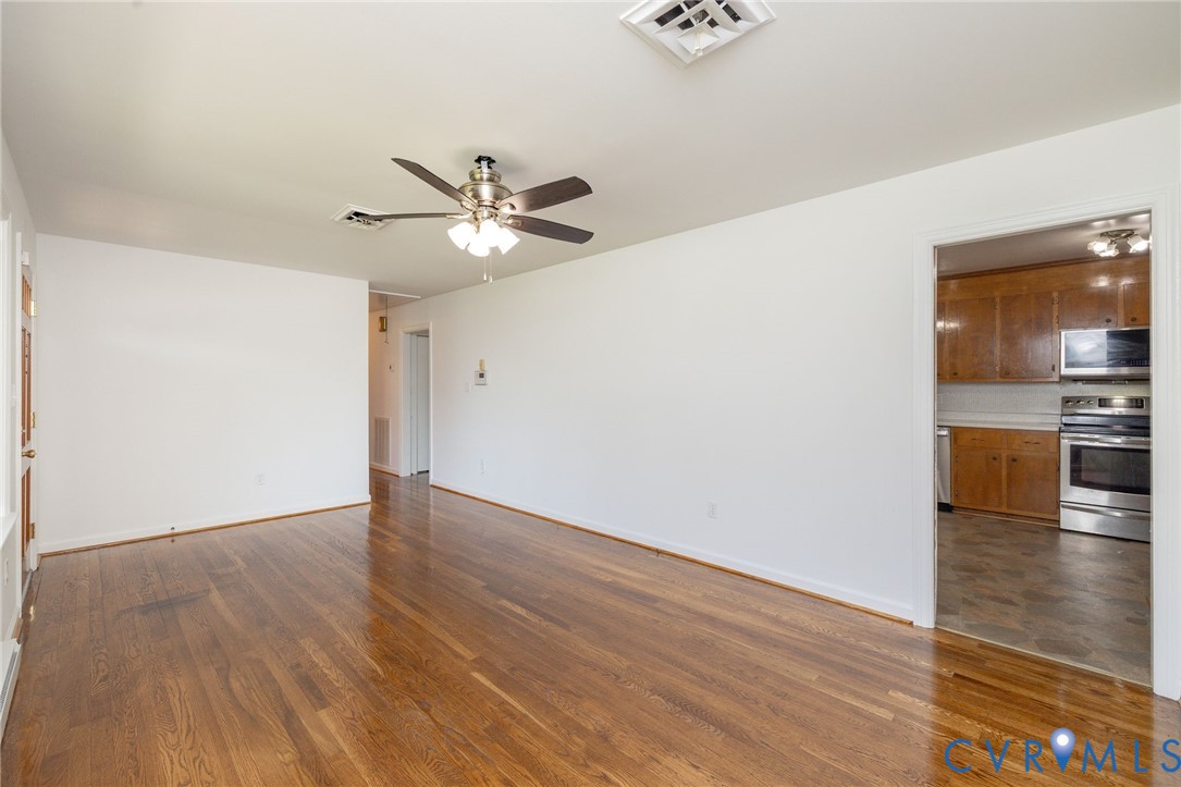 1210 Wellington Road Colonial Heights, VA 23834 - Photo 11 of 46 wooden floor in an empty room with a window