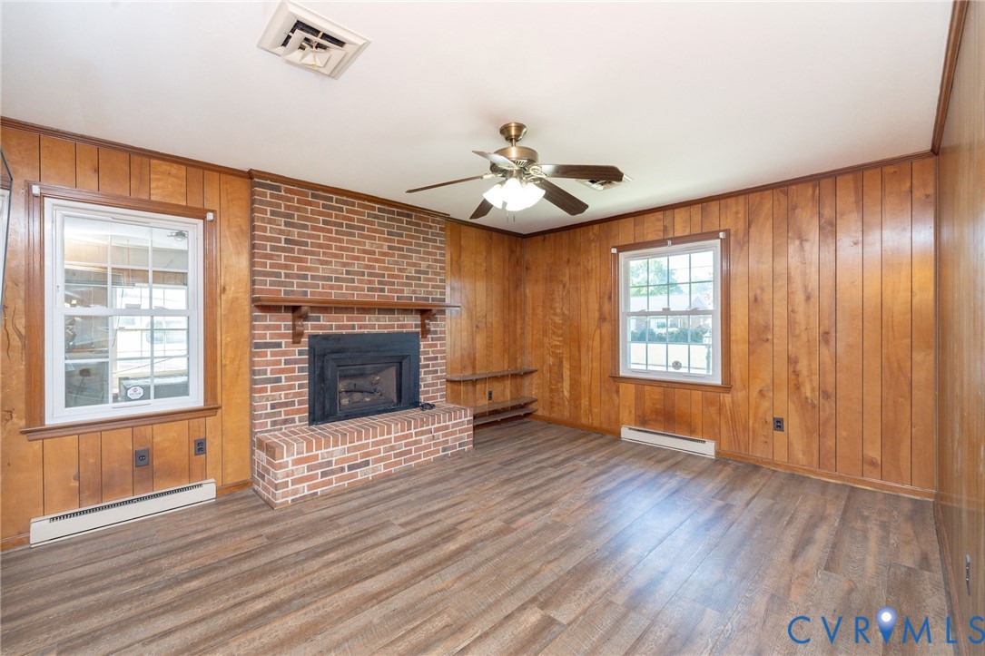 1210 Wellington Road Colonial Heights, VA 23834 - Photo 19 of 46 a view of an empty room with wooden floor fireplace and a window